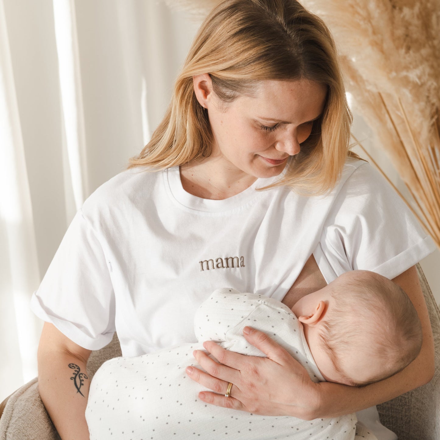mother breastfeeding baby wearing milkmates nursing t-shirt