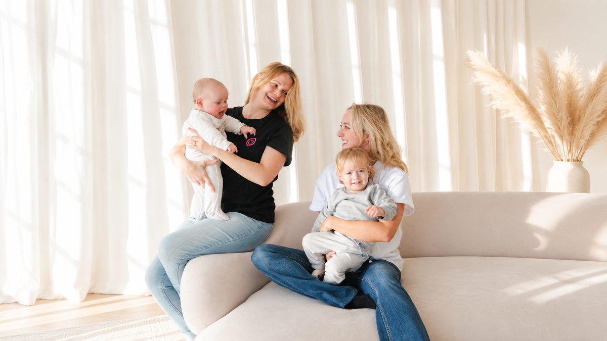 2 women wearing milkmates nursing shirts holding babies